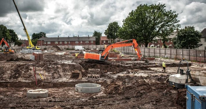Stor byggeplads med tunge maskiner